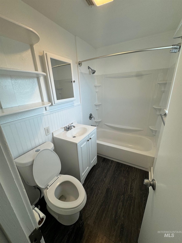 full bathroom featuring vanity, toilet, wood-type flooring, and bathing tub / shower combination