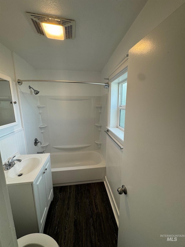 bathroom with vanity, wood-type flooring, and washtub / shower combination