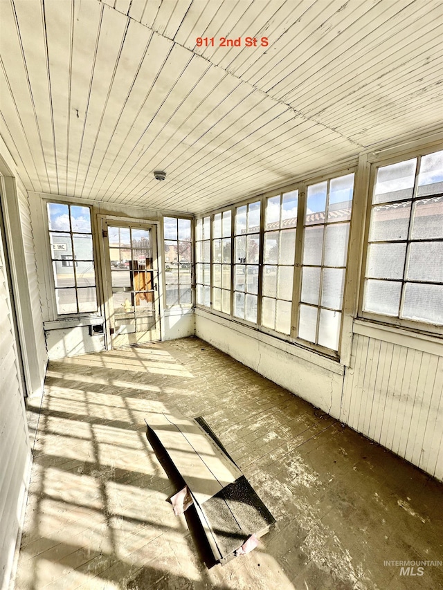 unfurnished sunroom featuring wood ceiling