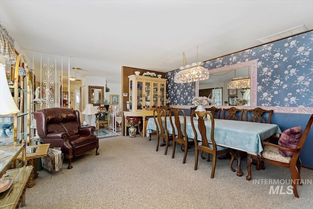 23743 Viking Ln, Wilder, ID 83676 - carpeted dining area featuring wallpapered walls and wainscoting