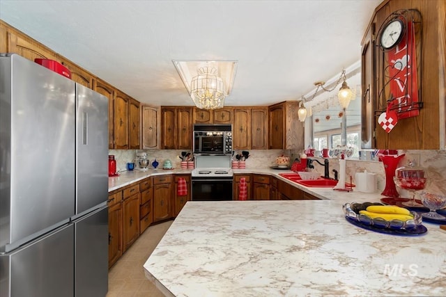 23743 Viking Ln, Wilder, ID 83676 - kitchen with freestanding refrigerator, electric stove, black microwave, light countertops, and a sink
