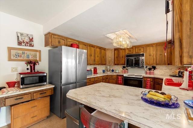 23743 Viking Ln, Wilder, ID 83676 - kitchen with appliances with stainless steel finishes, a sink, light countertops, tasteful backsplash, and a peninsula