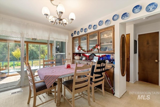 23743 Viking Ln, Wilder, ID 83676 - dining area featuring a chandelier and light tile patterned floors