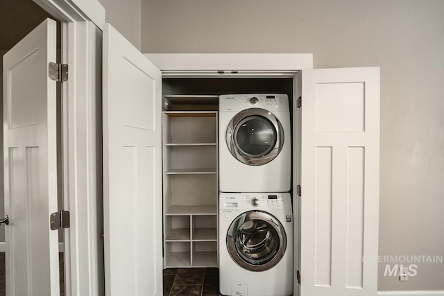 washroom featuring laundry area and stacked washer / dryer