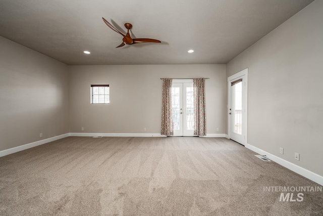 empty room with carpet floors, a wealth of natural light, and baseboards