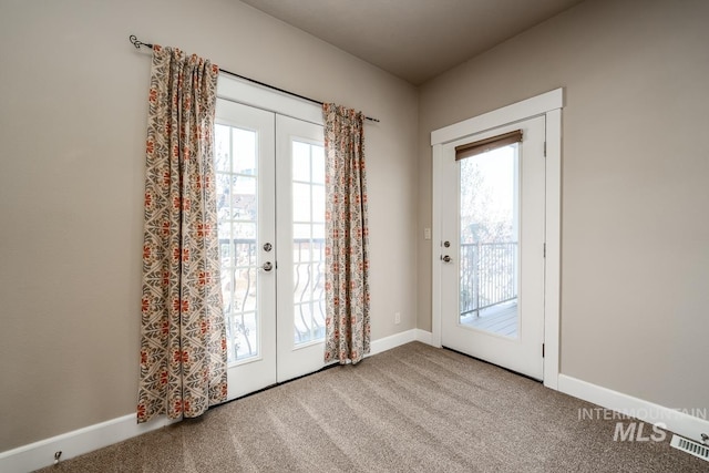 doorway with carpet floors, french doors, and a healthy amount of sunlight