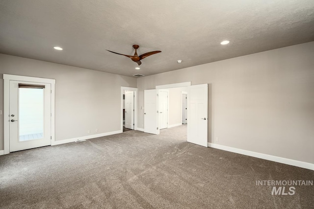 carpeted empty room featuring recessed lighting, visible vents, a textured ceiling, and baseboards