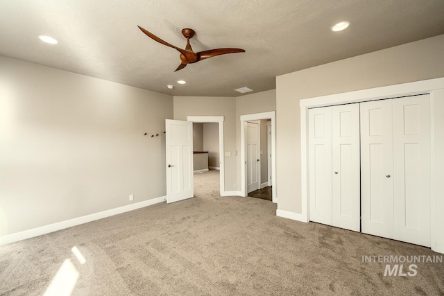 unfurnished bedroom with baseboards, a closet, carpet, and recessed lighting