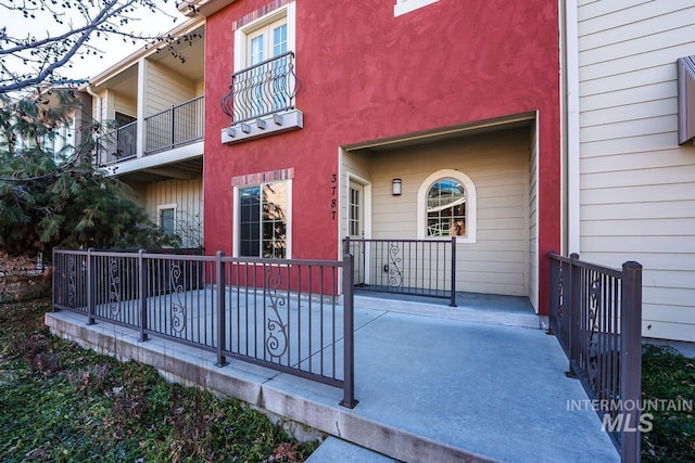 exterior space featuring a porch and stucco siding