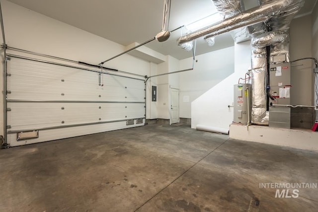 garage featuring electric panel and electric water heater