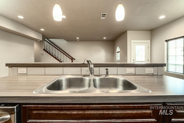 kitchen featuring dishwashing machine, visible vents, a sink, and recessed lighting