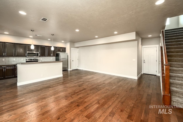 interior space featuring stairs, visible vents, dark wood-style flooring, and recessed lighting