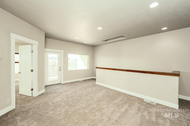 spare room with visible vents, baseboards, a textured ceiling, carpet flooring, and recessed lighting