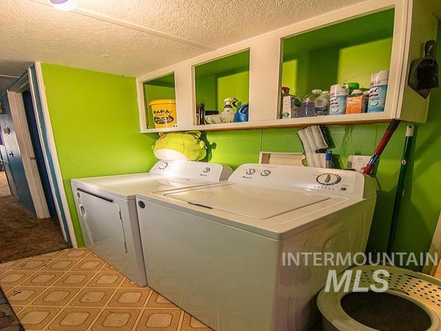 clothes washing area with washing machine and clothes dryer