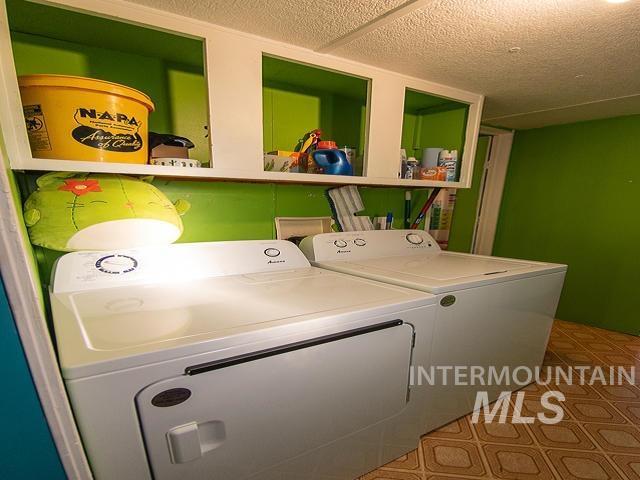 clothes washing area with separate washer and dryer