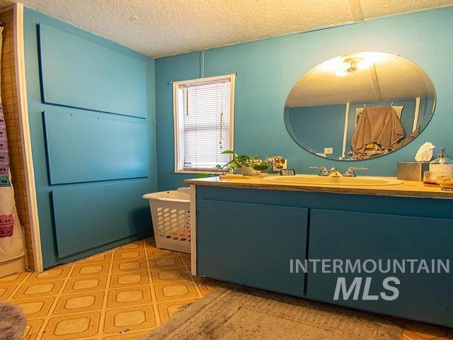 bathroom with vanity and a textured ceiling