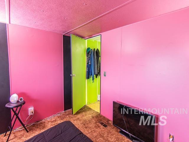 unfurnished bedroom with a closet, carpet flooring, and a textured ceiling