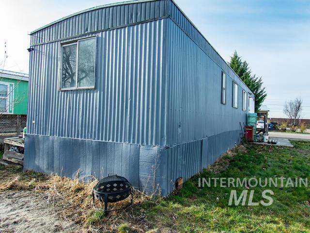 view of side of property featuring a fire pit