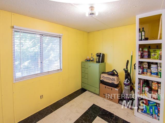 clothes washing area featuring a textured ceiling