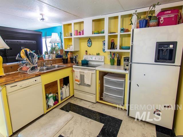 kitchen featuring sink and white appliances