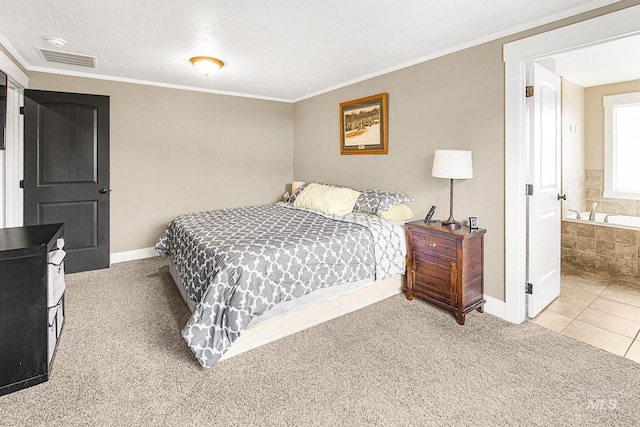 carpeted bedroom with crown molding and connected bathroom