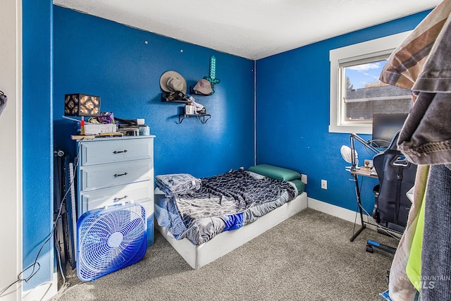 bedroom with a textured ceiling and carpet floors