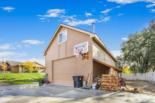 view of side of property featuring a garage and a yard