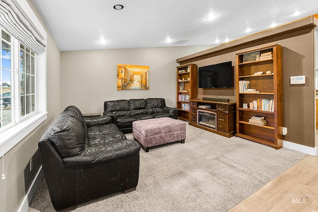 living room with vaulted ceiling and hardwood / wood-style flooring