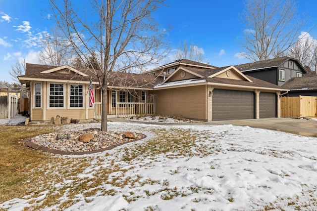 single story home with an attached garage and fence