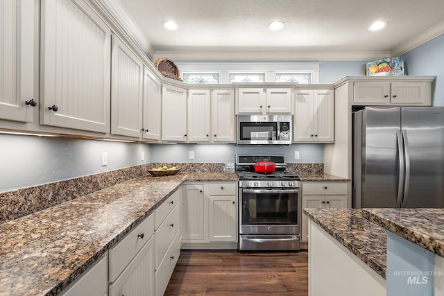998 E Shadow Creek Ln, Eagle, ID 83616 - kitchen with stainless steel appliances, crown molding, dark wood-style floors, dark stone countertops, and recessed lighting