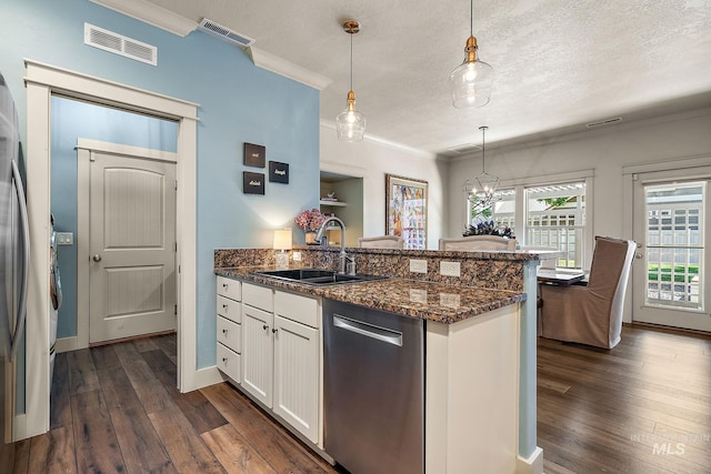 998 E Shadow Creek Ln, Eagle, ID 83616 - kitchen featuring dishwasher, a peninsula, crown molding, dark wood finished floors, and white cabinets