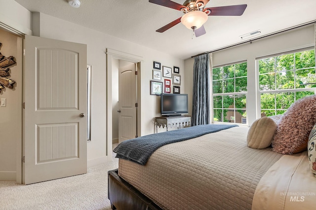 998 E Shadow Creek Ln, Eagle, ID 83616 - bedroom with light colored carpet, multiple windows, and ceiling fan