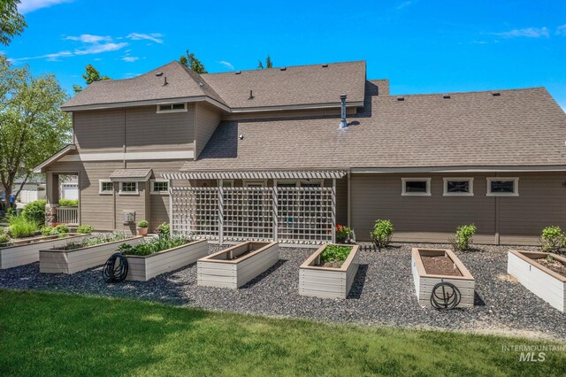 998 E Shadow Creek Ln, Eagle, ID 83616 - back of house with a vegetable garden and roof with shingles