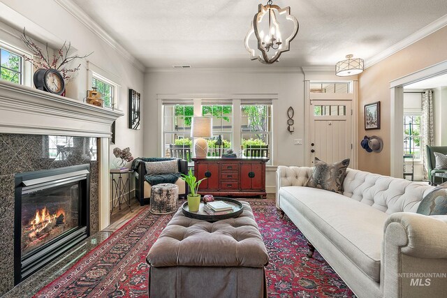 998 E Shadow Creek Ln, Eagle, ID 83616 - living area with a fireplace, healthy amount of natural light, ornamental molding, a chandelier, and wood finished floors