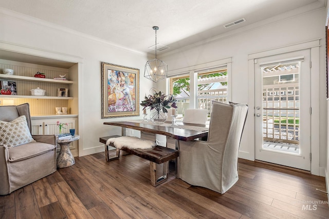 998 E Shadow Creek Ln, Eagle, ID 83616 - dining space with dark wood-style floors, crown molding, and a chandelier