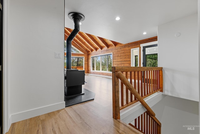 hall featuring hardwood / wood-style flooring, vaulted ceiling with beams, wooden ceiling, and wooden walls