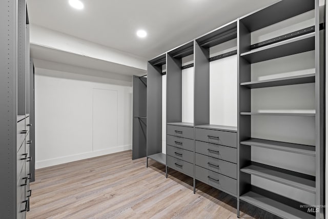 walk in closet featuring light hardwood / wood-style flooring