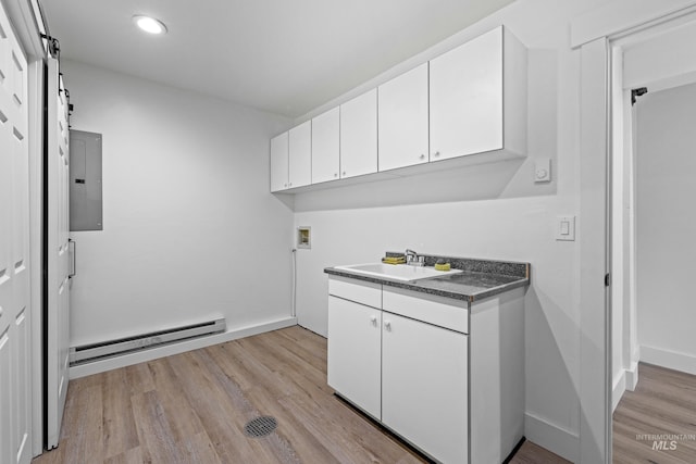 clothes washing area with sink, washer hookup, electric panel, baseboard heating, and a barn door