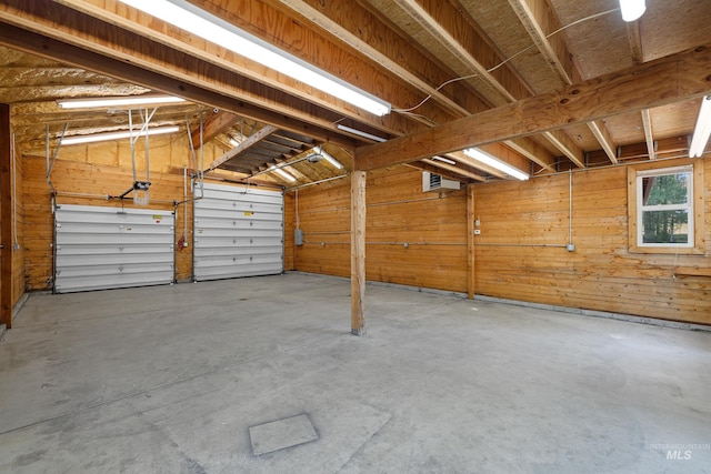 garage featuring wood walls