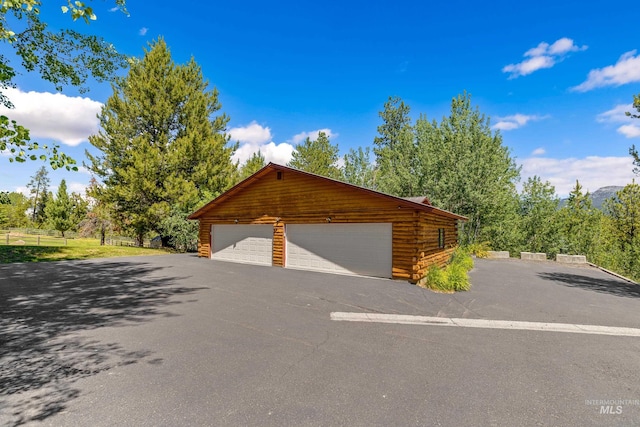 exterior space featuring a garage and an outdoor structure