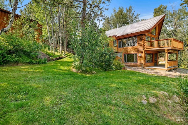 view of yard with a wooden deck and a patio