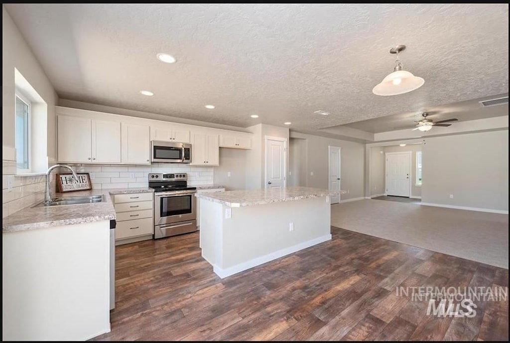11478 W Julianna Ct, Nampa, ID 83651 - kitchen featuring stainless steel appliances, a sink, dark wood-type flooring, white cabinetry, and recessed lighting
