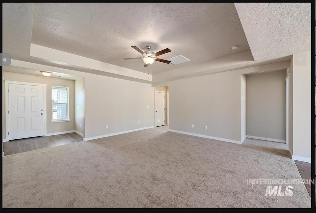 11478 W Julianna Ct, Nampa, ID 83651 - spare room with a raised ceiling, a textured ceiling, carpet, and a ceiling fan