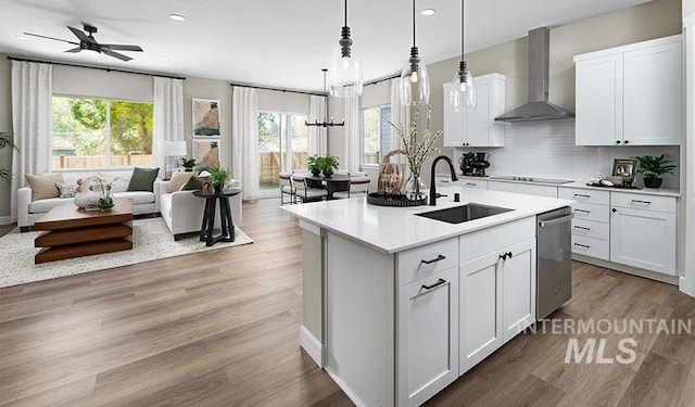 2386 N Ice Fire Ave, Star, ID 83669 - kitchen with wall chimney range hood, a sink, stainless steel dishwasher, open floor plan, and recessed lighting