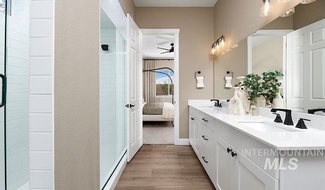 2386 N Ice Fire Ave, Star, ID 83669 - full bathroom featuring a ceiling fan, ensuite bath, double vanity, wood finished floors, and a tile shower