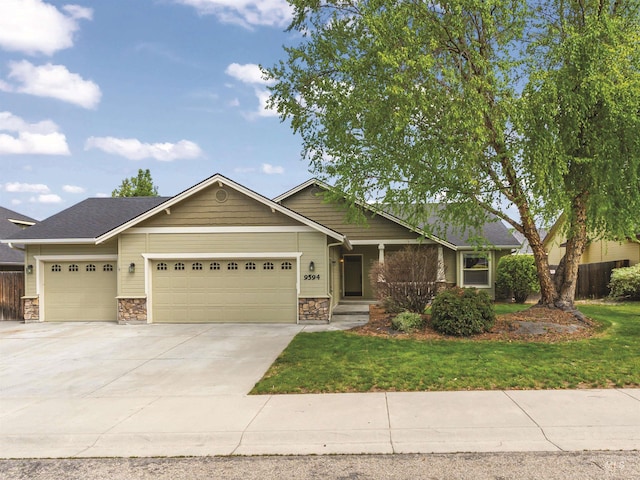 view of front of property featuring an attached garage, stone siding, and driveway
