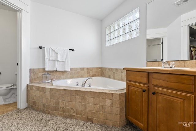 full bathroom with a bath, toilet, vanity, and tile patterned flooring