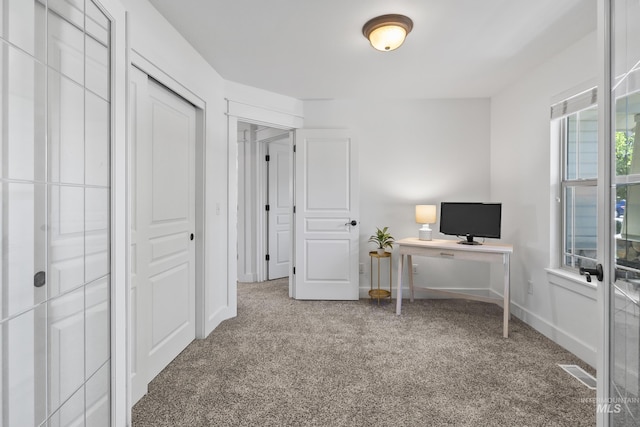 home office featuring carpet flooring and baseboards