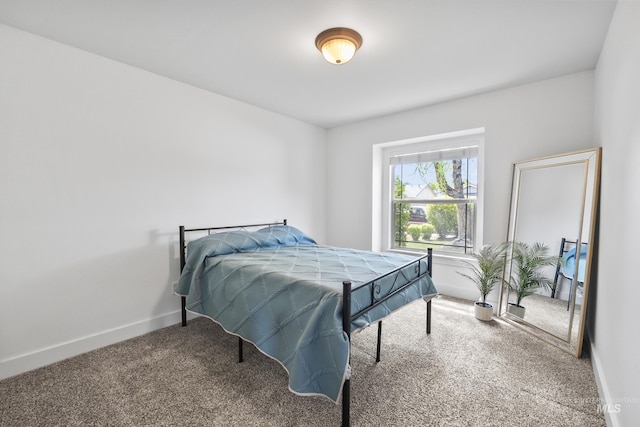 carpeted bedroom featuring baseboards