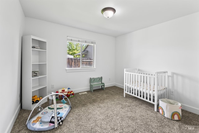 bedroom with carpet flooring, baseboards, and a nursery area
